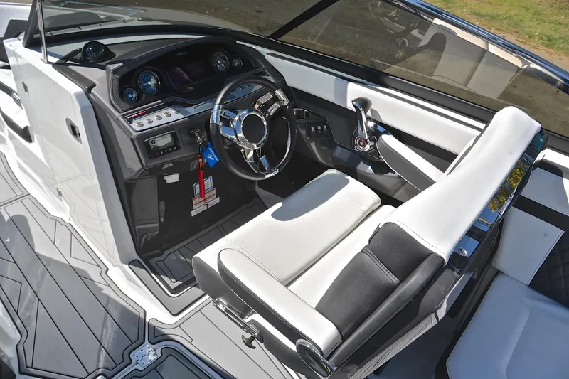 Slide: The Image of 2023 Monterey 275SS Super Sport boat interior with sleek dashboard and modern steering wheel. - 25