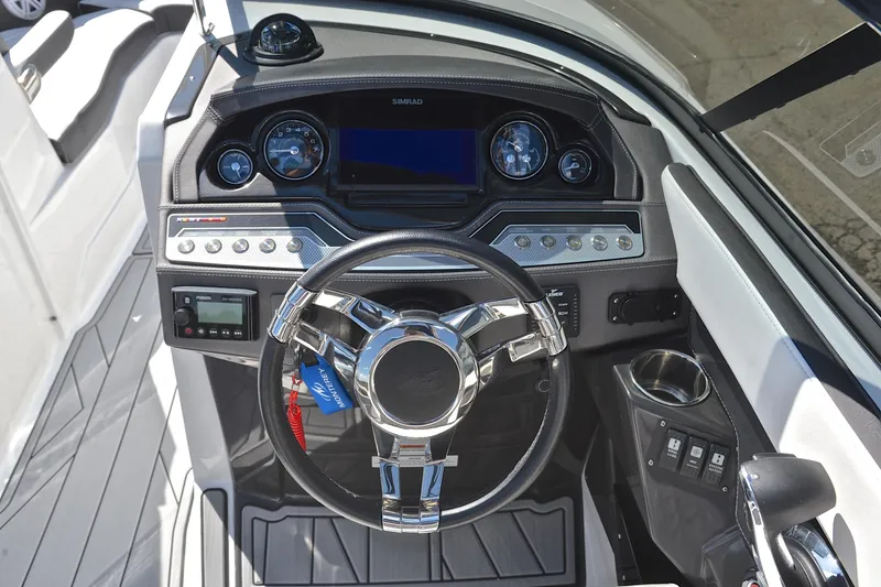 Slide: The Image of 2023 Monterey 275SS Super Sport boat dashboard with steering wheel and control panel. - 26