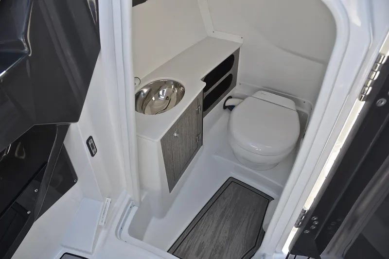 Slide: The Image of 2023 Monterey 275SS Super Sport boat bathroom with toilet and sink. - 28