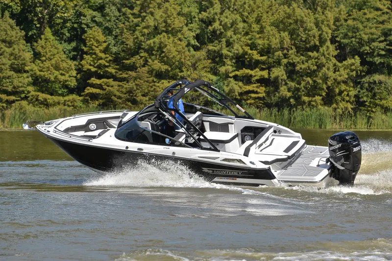 Slide: The Image of 2023 Monterey 275SS Super Sport boat cruising on a lake with lush green trees. - 6