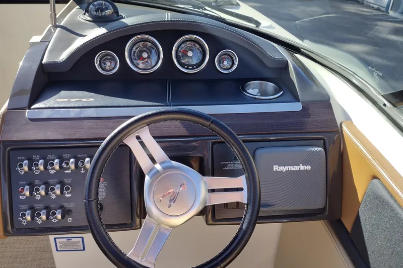 Slide: The Image of Dashboard of 2014 Sea Ray 270 SLX boat with steering wheel and Raymarine system. - 11