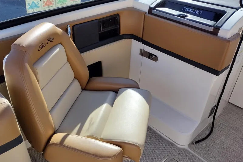 Slide: The Image of 2014 Sea Ray 270 SLX boat interior with tan and cream seating. - 13