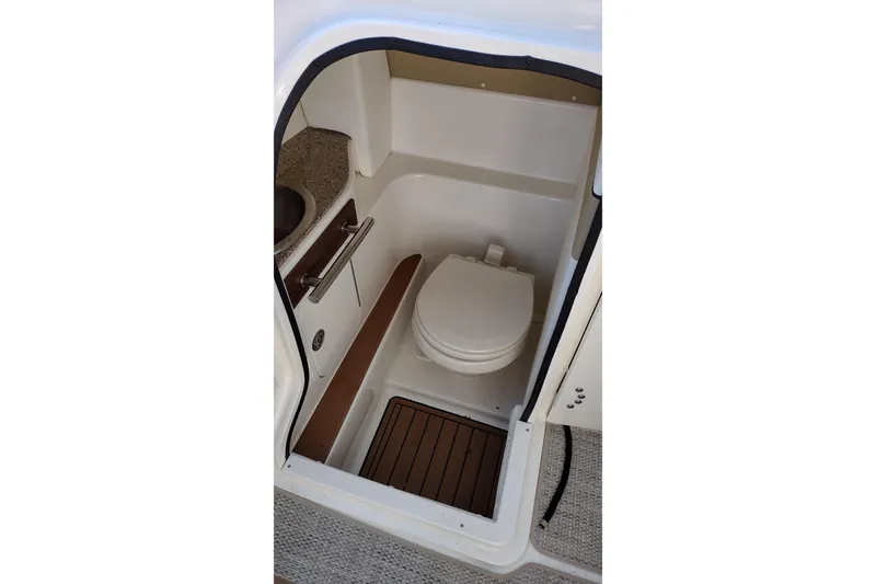 Slide: The Image of 2014 Sea Ray 270 SLX boat bathroom with toilet and sink. - 16