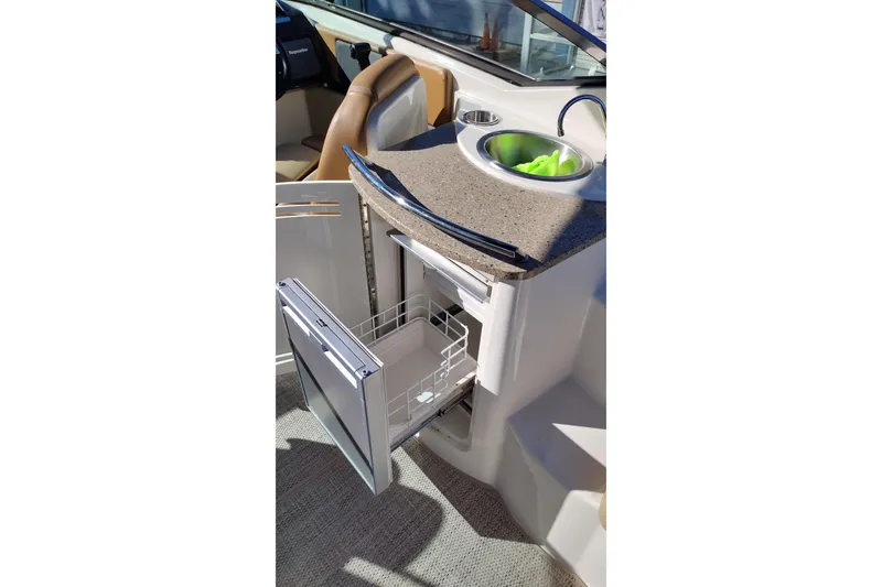 Slide: The Image of 2014 Sea Ray 270 SLX boat interior with open drawer and sink. - 19