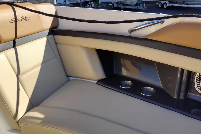 Slide: The Image of 2014 Sea Ray 270 SLX boat interior with beige seating and cup holders. - 23