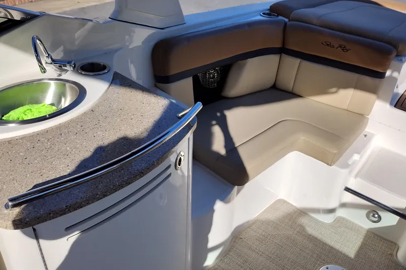 Slide: The Image of 2014 Sea Ray 270 SLX boat interior with sink and cushioned seating. - 26