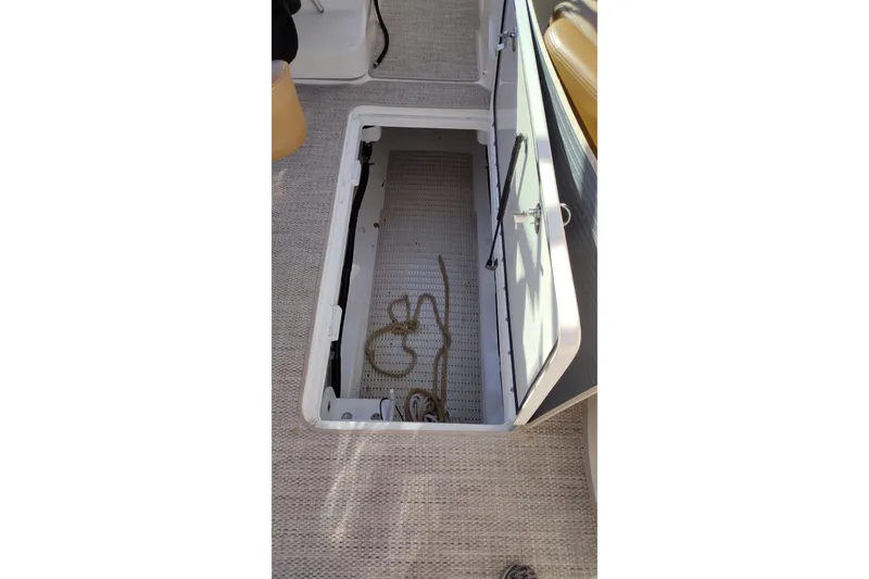 Slide: The Image of Open storage compartment on 2014 Sea Ray 270 SLX boat, featuring a rope inside. - 29