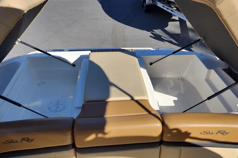 Slide: The Image of 2014 Sea Ray 270 SLX boat interior with open storage compartments and cushioned seating. - 30