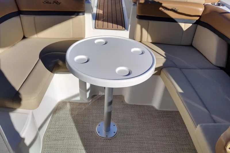 Slide: The Image of 2014 Sea Ray 270 SLX boat interior with round table and cushioned seating. - 33