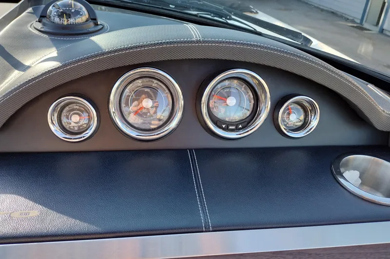 Slide: The Image of Dashboard of a 2014 Sea Ray 270 SLX boat with gauges and compass. - 36