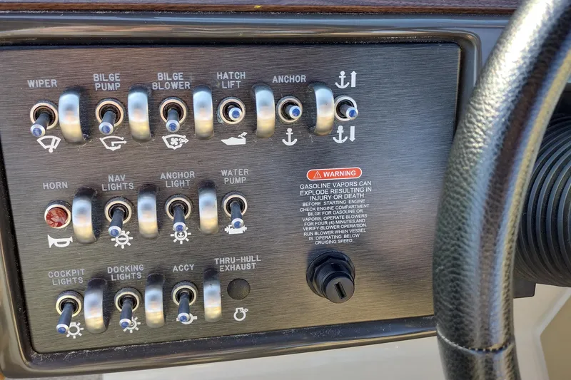Slide: The Image of Control panel of a 2014 Sea Ray 270 SLX boat with various switches and warning label. - 37