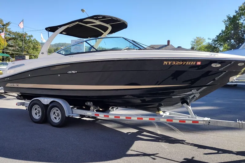 Slide: The Image of 2014 Sea Ray 270 SLX boat on trailer, black hull, parked outdoors. - 4