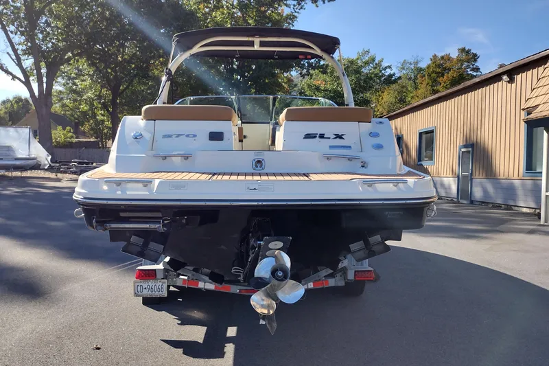 Slide: The Image of 2014 Sea Ray 270 SLX boat on trailer, rear view, sunny day, outdoor setting. - 7