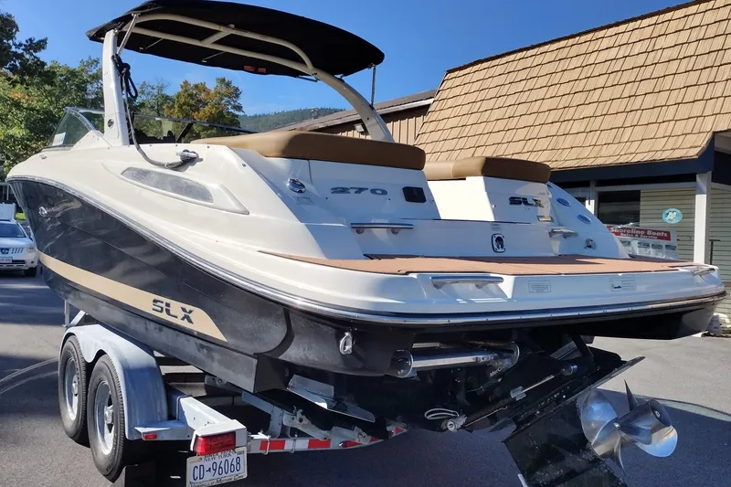Slide: The Image of 2014 Sea Ray 270 SLX boat on trailer, parked outdoors near a building. - 8