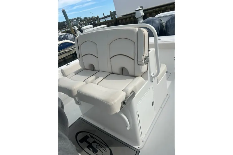 Slide: The Image of 2021 Sea Hunt Gamefish 27 Coffin Box boat seating area with white cushioned seats. - 14