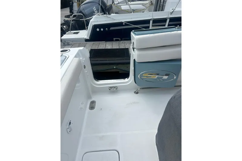 Slide: The Image of 2021 Sea Hunt Gamefish 27 Coffin Box boat interior with open storage compartment. - 15