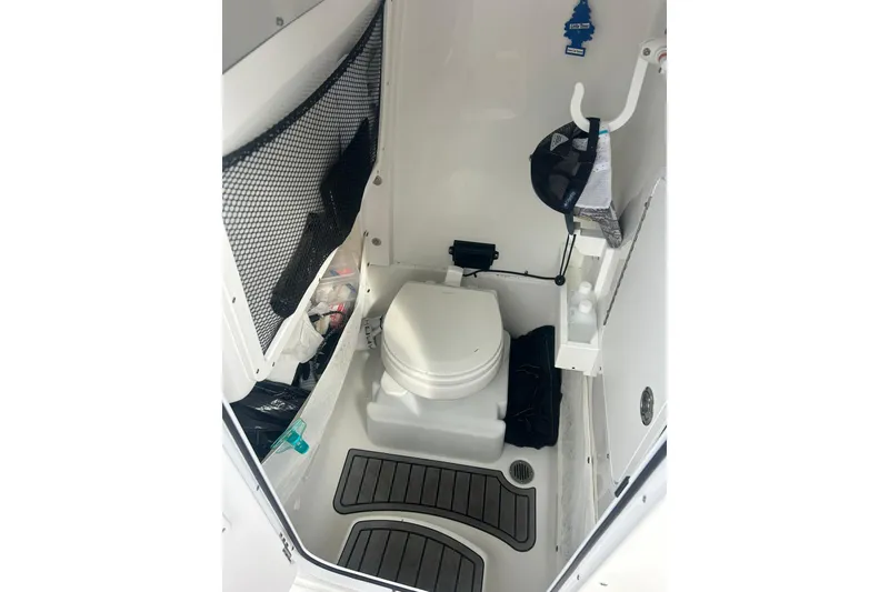 Slide: The Image of 2021 Sea Hunt Gamefish 27 Coffin Box boat interior with toilet and storage. - 20