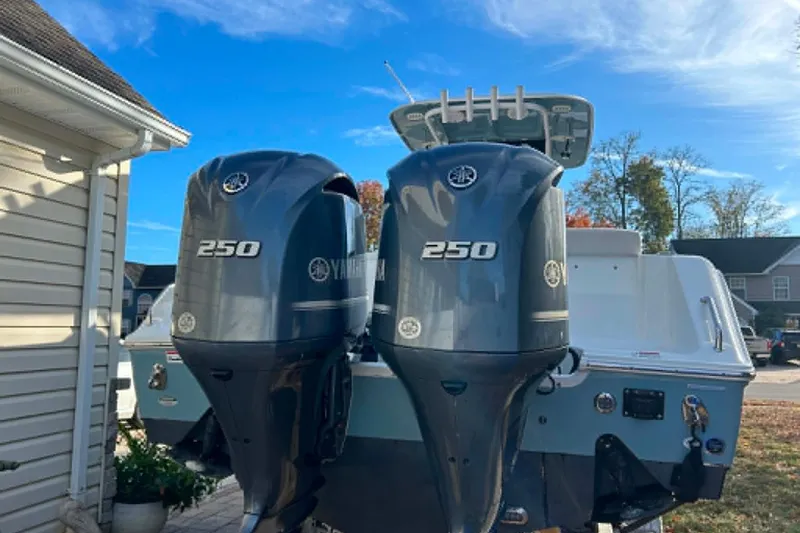 Slide: The Image of 2021 Sea Hunt Gamefish 27 Coffin Box with twin Yamaha 250 engines, parked outdoors. - 24