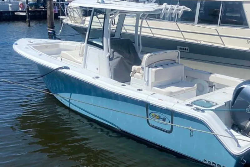 Slide: The Image of 2021 Sea Hunt Gamefish 27 Coffin Box boat docked in marina, featuring sleek design. - 28