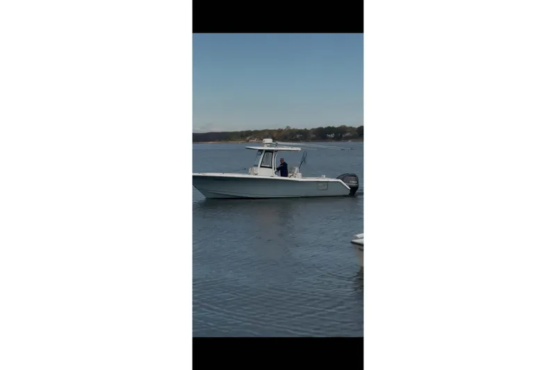 Slide: The Image of 2021 Sea Hunt Gamefish 27 Coffin Box boat on calm water. - 30
