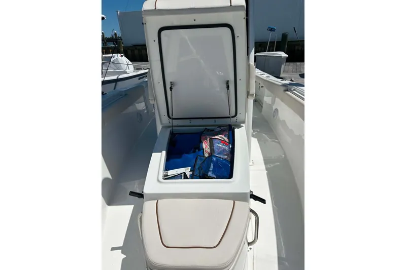 Slide: The Image of 2021 Sea Hunt Gamefish 27 Coffin Box open, revealing storage contents on a sunny day. - 31