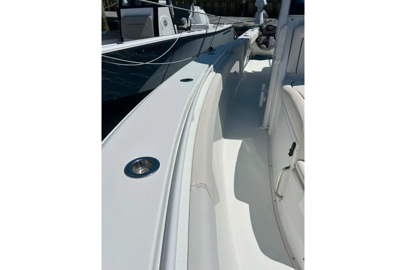 Slide: The Image of 2021 Sea Hunt Gamefish 27 Coffin Box boat interior, showcasing sleek design and seating. - 33
