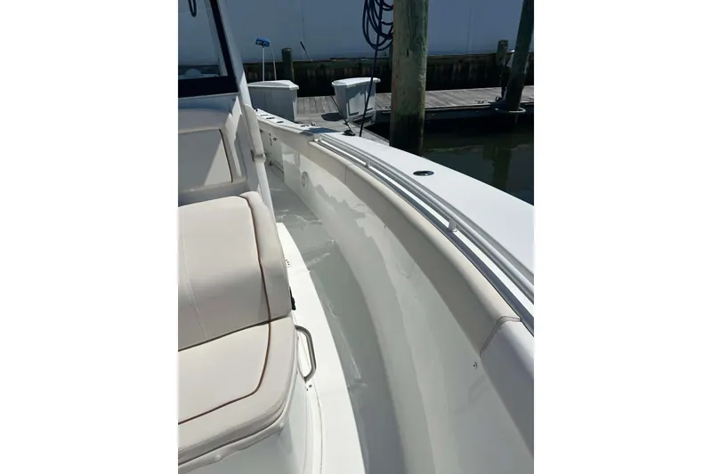 Slide: The Image of 2021 Sea Hunt Gamefish 27 Coffin Box boat interior with seating, docked at marina. - 34