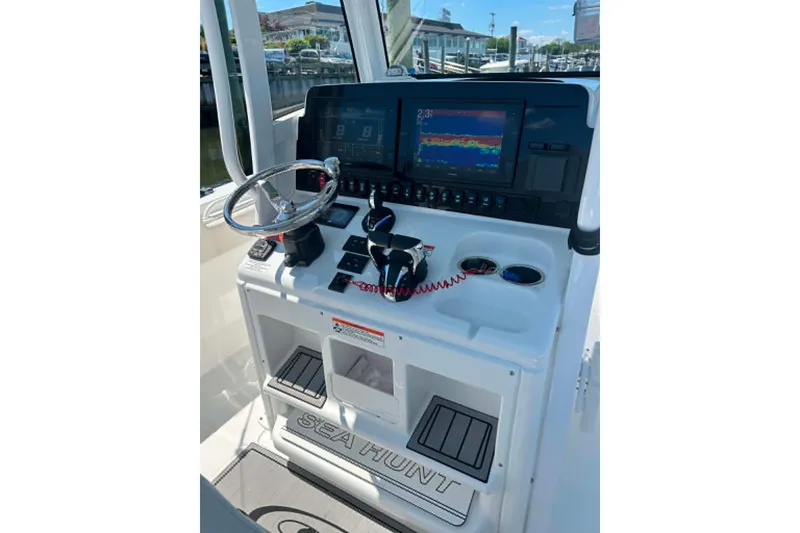 Slide: The Image of Control panel of 2021 Sea Hunt Gamefish 27 Coffin Box with navigation screens and steering wheel. - 35