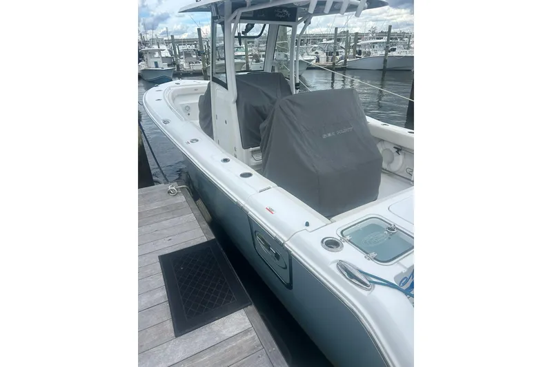 Slide: The Image of 2021 Sea Hunt Gamefish 27 Coffin Box boat docked at marina. - 5