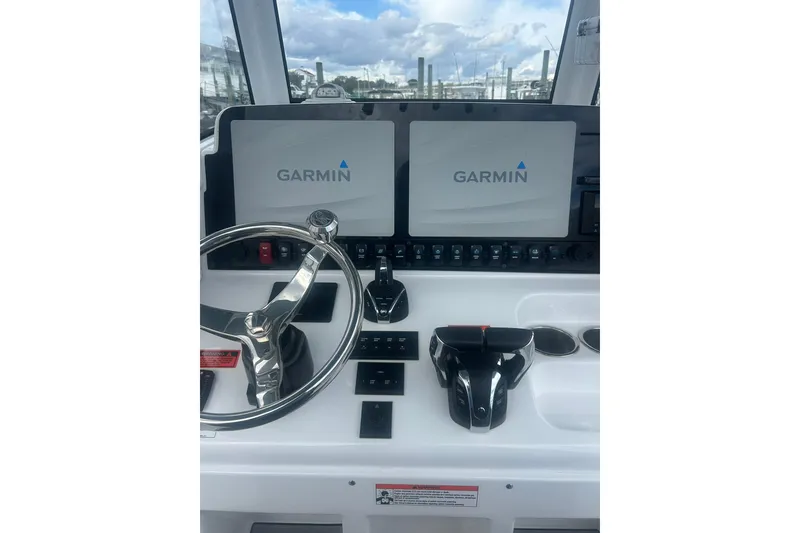 Slide: The Image of 2021 Sea Hunt Gamefish 27 Coffin Box helm with Garmin displays and controls. - 8