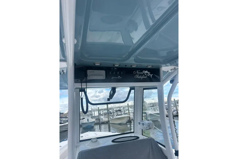 Slide: The Image of 2021 Sea Hunt Gamefish 27 Coffin Box boat interior with marina view. - 9