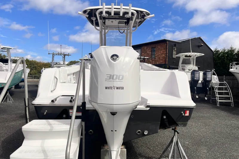 Slide: The Image of 2024 Sportsman Open 242 Center Console boat displayed outdoors. - 2