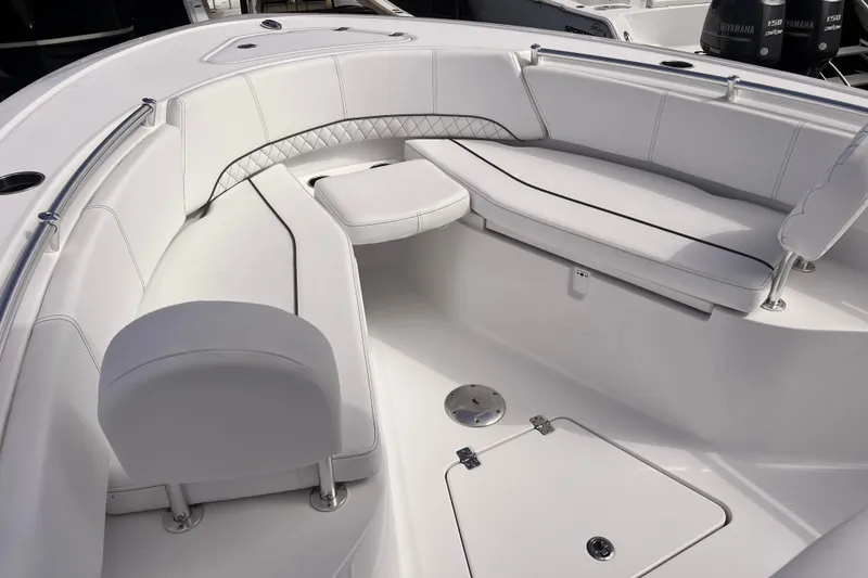 Slide: The Image of 2024 Sportsman Open 242 Center Console boat with white cushioned seating area. - 7