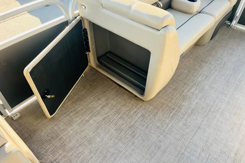 Slide: The Image of 2022 Sun Tracker Party Barge 20 DLX interior storage compartment with open door. - 12