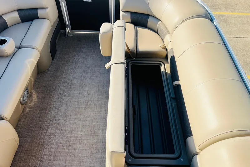 Slide: The Image of 2022 Sun Tracker Party Barge 20 DLX interior with open storage compartment. - 17