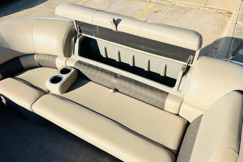 Slide: The Image of 2022 Sun Tracker Party Barge 20 DLX interior with storage and cup holders. - 19