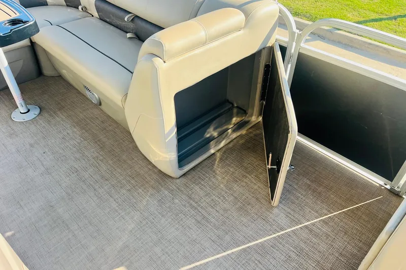 Slide: The Image of 2022 Sun Tracker Party Barge 20 DLX interior with open storage compartment. - 22