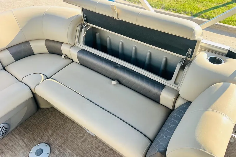 Slide: The Image of 2022 Sun Tracker Party Barge 20 DLX seating with storage compartment open. - 25