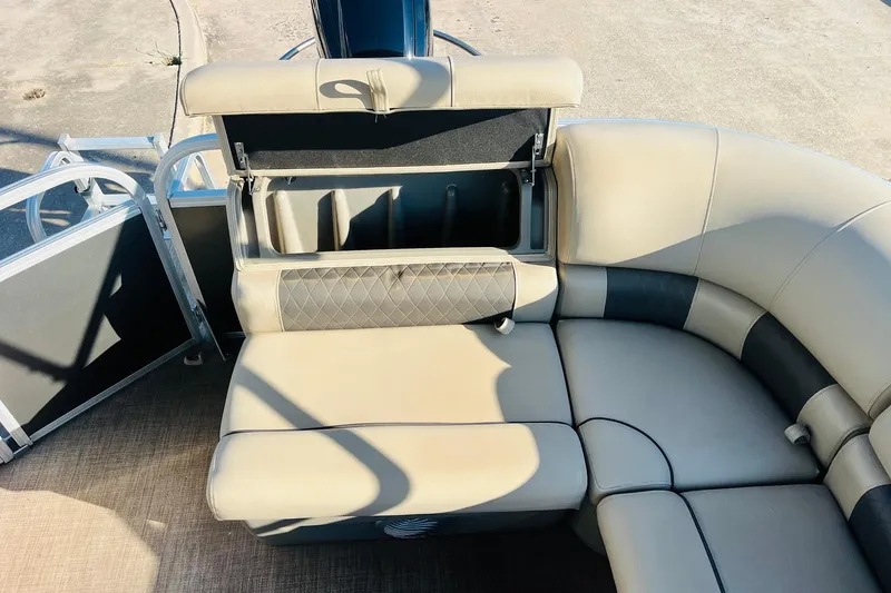 Slide: The Image of 2022 Sun Tracker Party Barge 20 DLX interior seating with storage compartment open. - 28