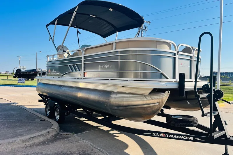 Slide: The Image of 2022 Sun Tracker Party Barge 20 DLX pontoon boat on trailer, parked outdoors. - 3