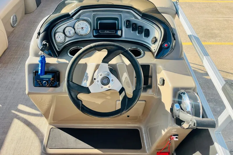 Slide: The Image of 2022 Sun Tracker Party Barge 20 DLX dashboard with steering wheel and controls. - 31