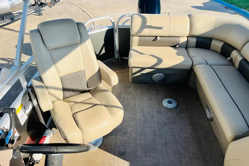 Slide: The Image of Interior of 2022 Sun Tracker Party Barge 20 DLX with beige seating and steering wheel. - 33