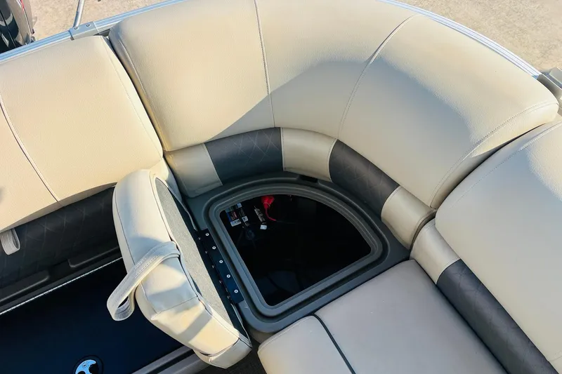 Slide: The Image of 2022 Sun Tracker Party Barge 20 DLX seating with storage compartment open. - 35