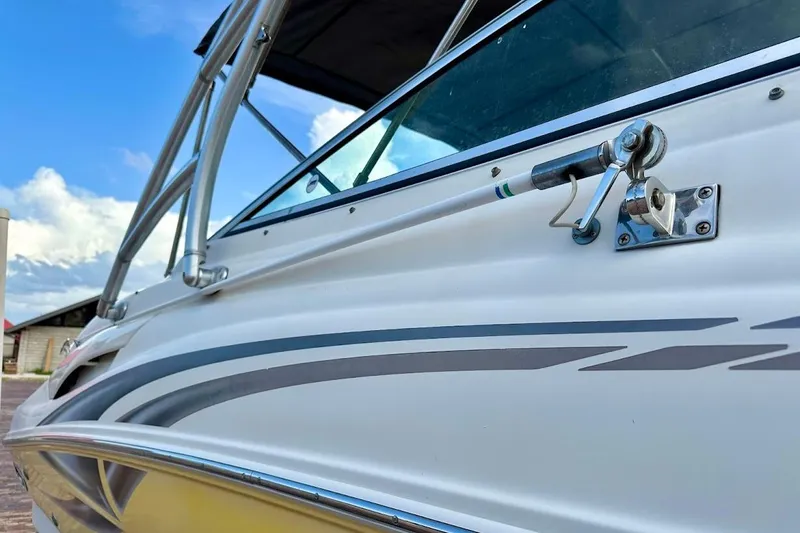 Slide: The Image of Close-up of 2004 Sea Ray 270 Sundeck boat exterior with sleek design and metal fittings. - 12
