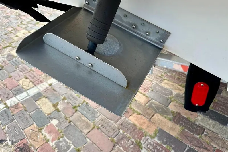Slide: The Image of Trim tab of a 2004 Sea Ray 270 Sundeck on a cobblestone surface. - 15