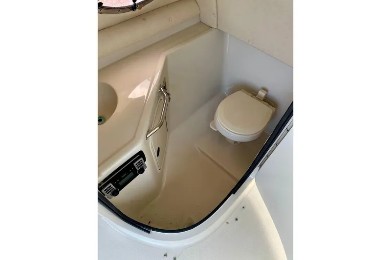 Slide: The Image of 2004 Sea Ray 270 Sundeck boat bathroom interior with toilet and sink. - 29