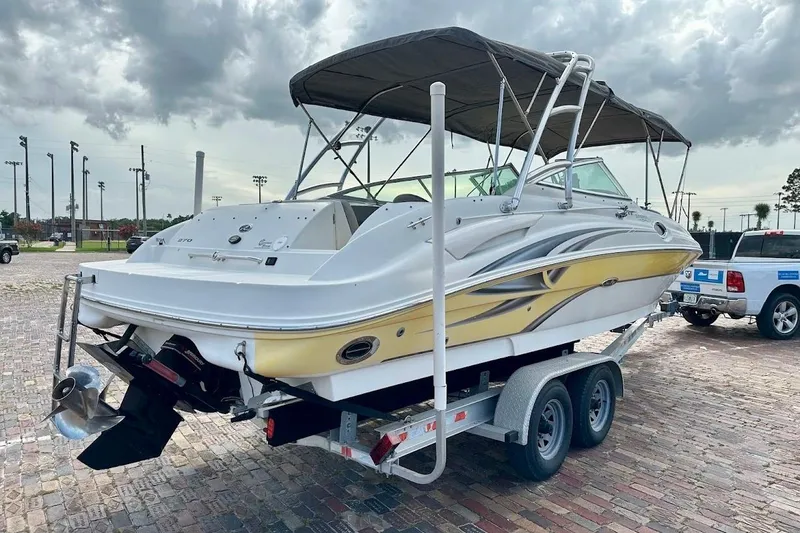 Slide: The Image of 2004 Sea Ray 270 Sundeck boat on trailer under cloudy sky. - 3
