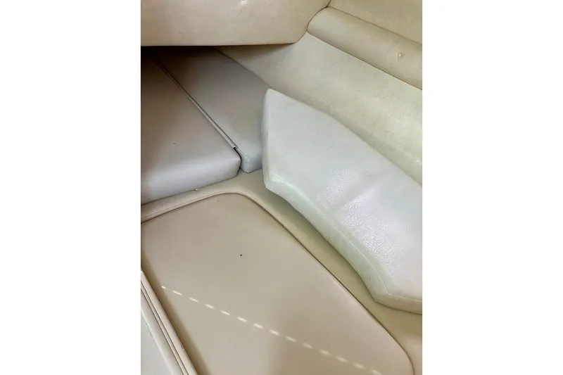 Slide: The Image of Interior seating of 2004 Sea Ray 270 Sundeck boat, featuring beige upholstery. - 36