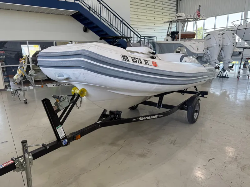 The Image of 2009 Walker Bay Generation 430 boat on trailer in showroom. - 0