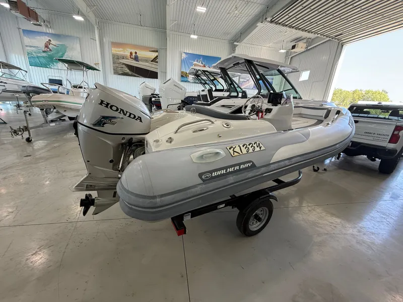 Slide: The Image of 2009 Walker Bay Generation 430 boat with Honda engine in showroom. - 3